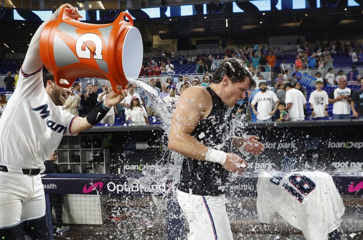 Jul 27, 2026; Miami, Florida, USA;  Miami Marlins catcher Joe Mack (80) douses left fielder Griffin Conine (18) after his winning hit against the Philadelphia Phillies following the game at loanDepot Park. Mandatory Credit: Rhona Wise-Imagn Images