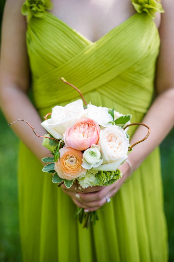 Peach and white ranunculus with a coral peony and green hydrangea