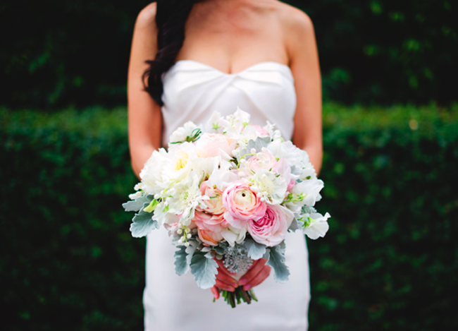 Bridal bouquet with bright pink ranunculus, blush blooms and dusty miller