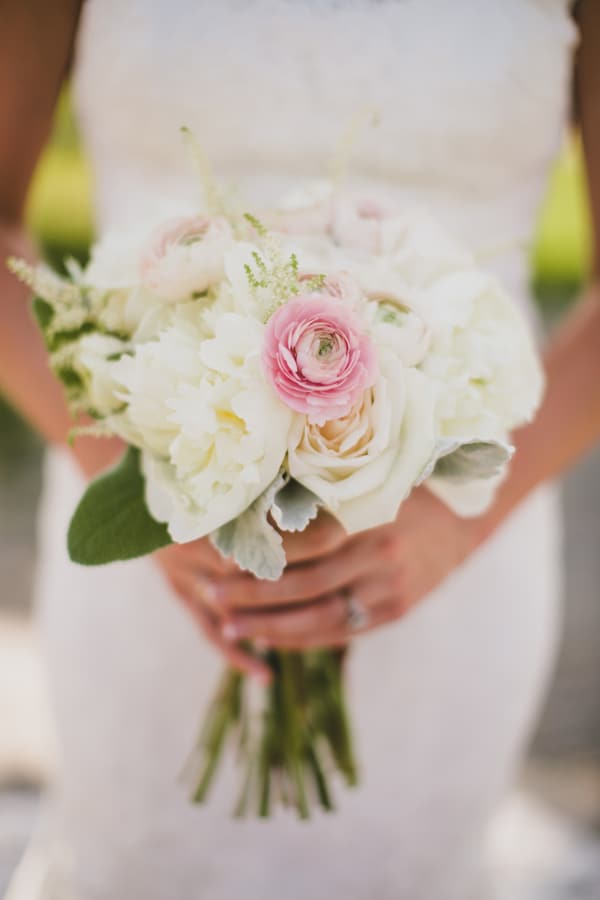 Pink ranunculus as the focal flower with white roses, astilbe and dusty miller