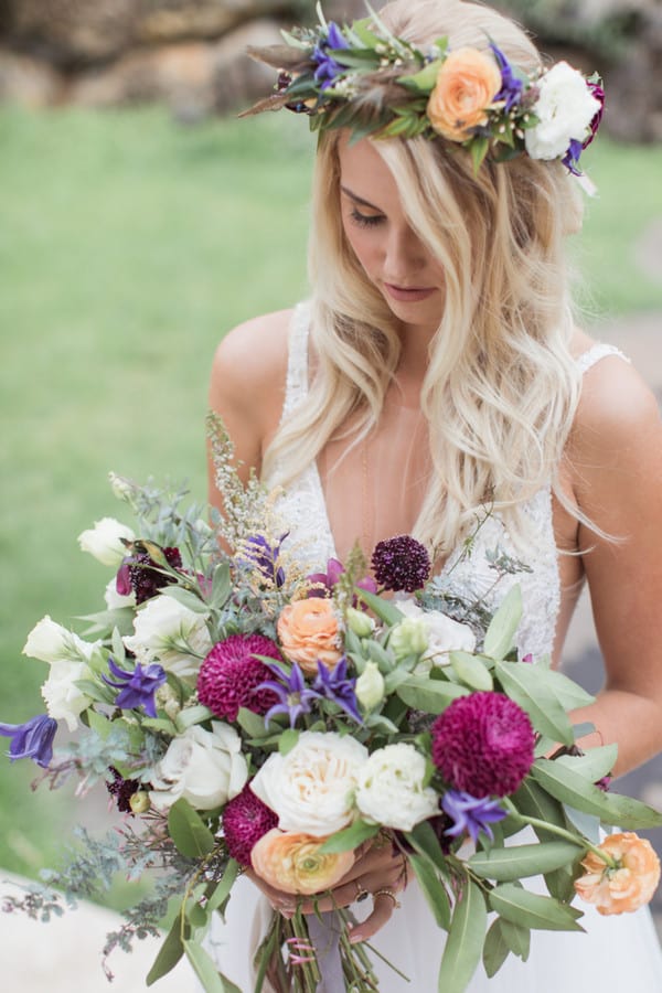 Peach ranunculus with magenta dahlias, white roses and purple clematis