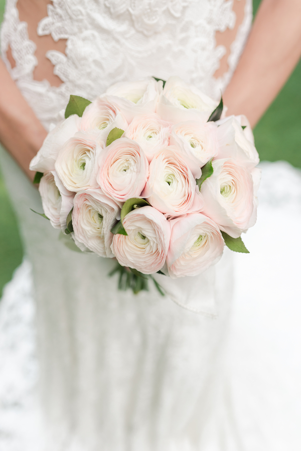 Round bouquet made entirely of pale blush pink ranunculus
