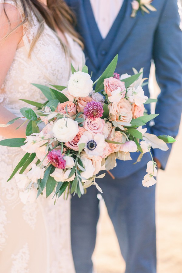 White ranunculus with blush garden roses, an anemone and pink scabiosa