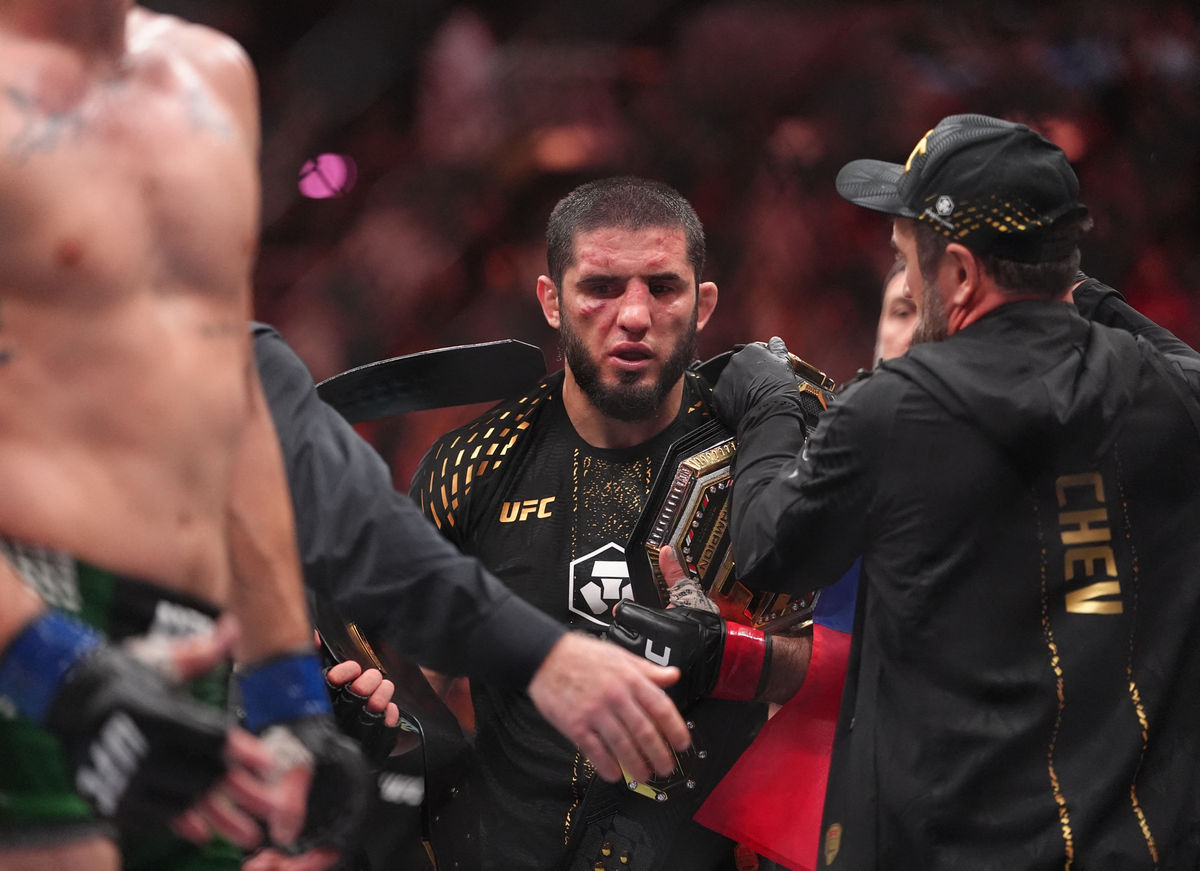 Aug 15, 2026; Philadelphia, Pennsylvania, USA; Islam Makhachev (red gloves) celebrates after defeating Ian Machado Garry (blue gloves) in the welterweight title bout during UFC 330 at Xfinity Mobile Arena. Mandatory Credit: Kyle Ross-Imagn Images