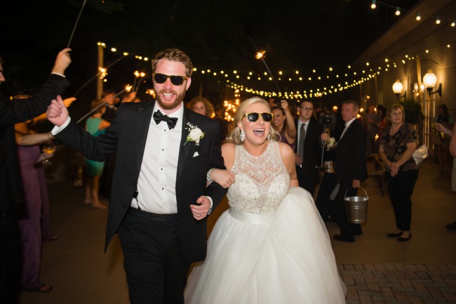 Sparkler sendoff with the couple and guests wearing sunglasses
