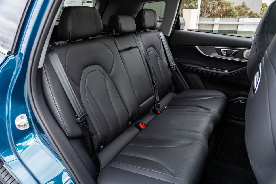 Rear seat interior of a 2026 Chery Tiggo 7 Super Hybrid showing black leather upholstery with white contrast stitching and three seatbelts