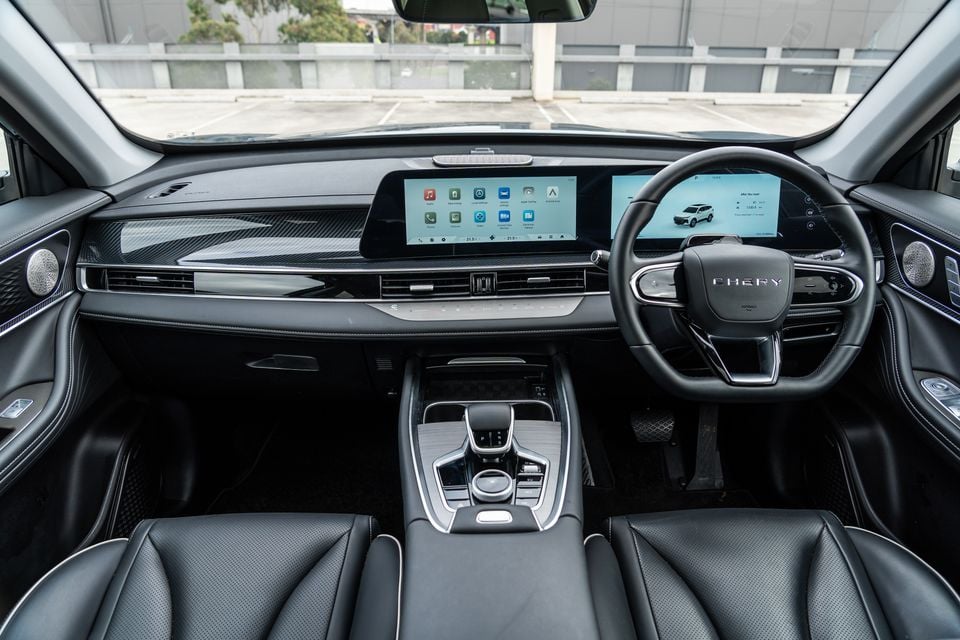 Interior of a 2026 Chery Tiggo 7 Super Hybrid showing the dashboard, dual touchscreens, steering wheel, and centre console from the front passenger perspective