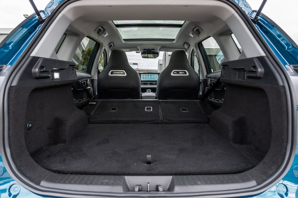 Boot of a blue 2026 Chery Tiggo 7 Super Hybrid with rear seats folded flat, showing a large, empty cargo area with a sunroof visible through the cabin