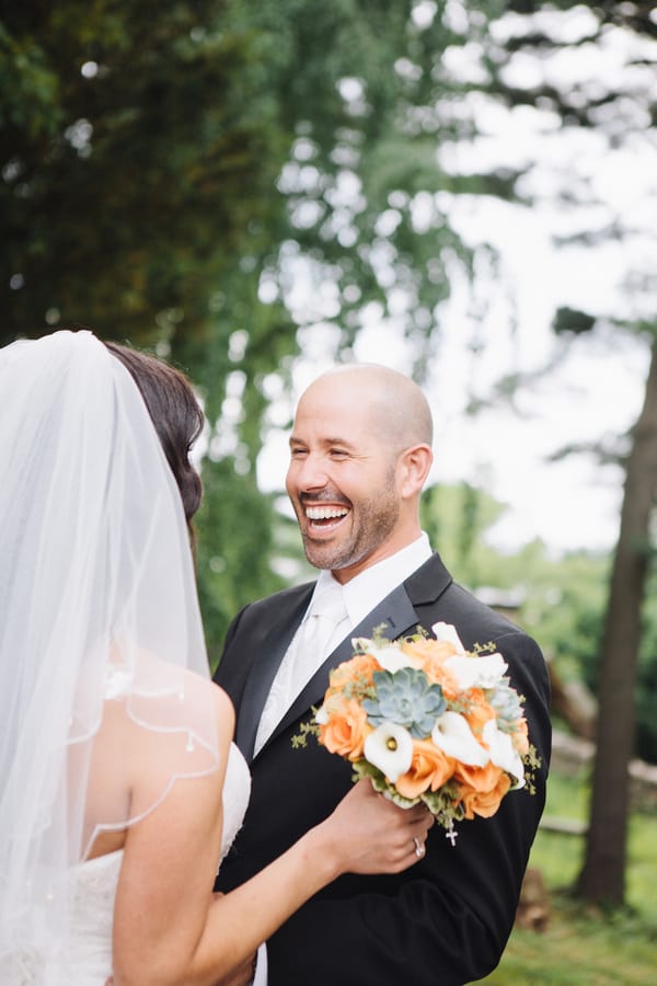 Bouquet of peach roses mixed with grey-green succulents and white calla lilies