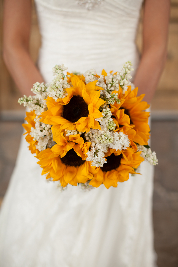 Sunflower bouquet filled with clusters of white lilac
