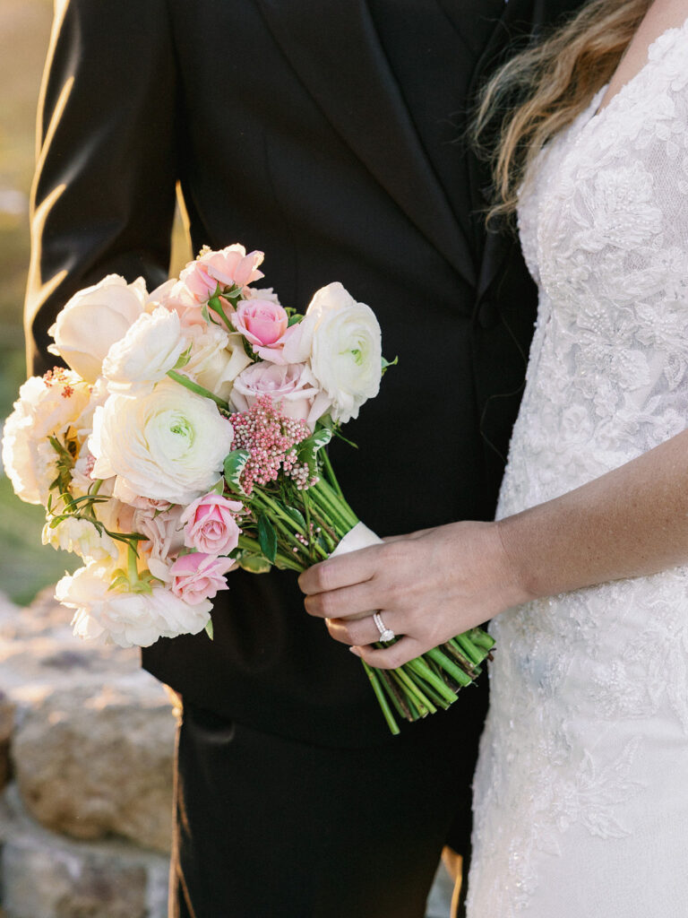 Bride holding a clean blush and cream rose bouquet