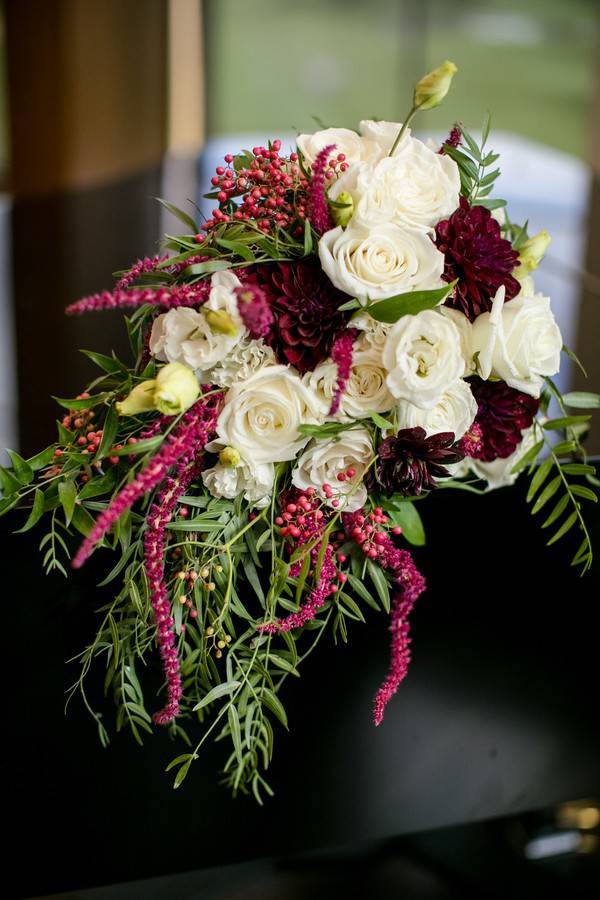 Cascading burgundy and white rose bridal bouquet close-up
