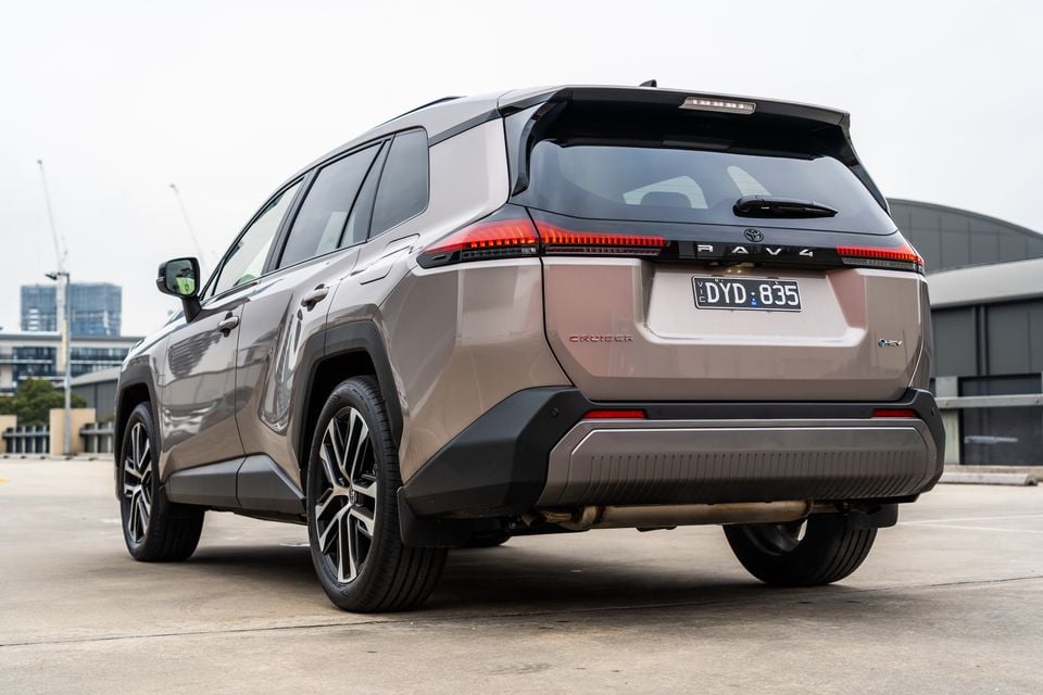 A bronze 2026 Toyota RAV4 Cruiser SUV parked on a rooftop, viewed from the rear quarter angle.