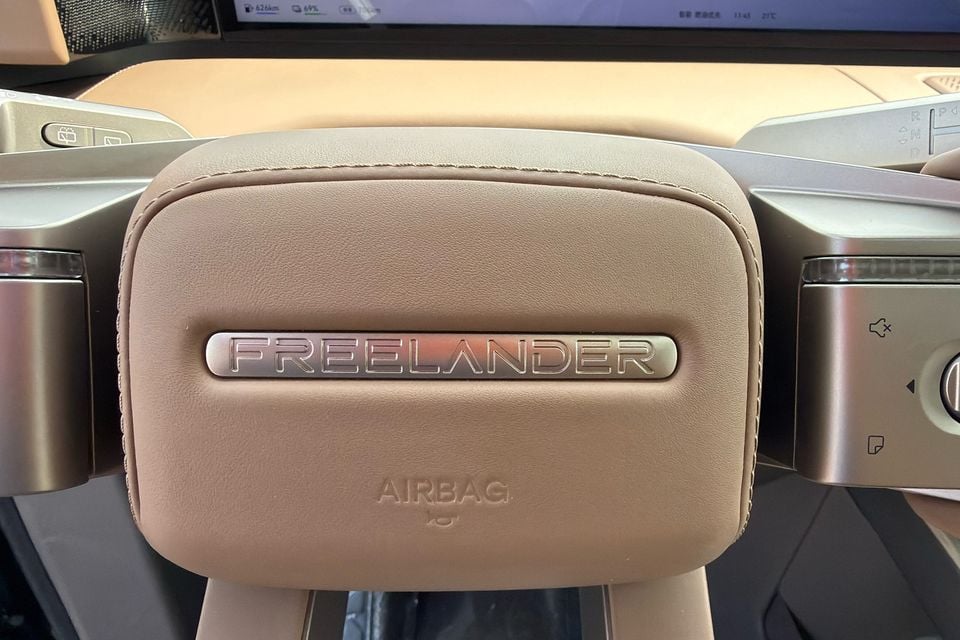 Freelander badge on the centre of the tan steering wheel