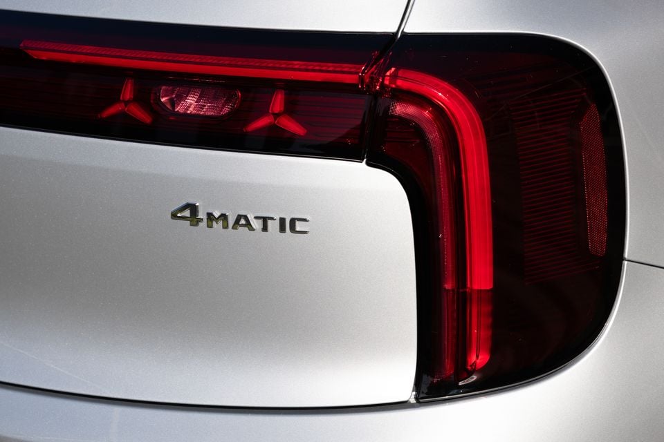 Close-up of the tail-light and 4MATIC badge on the rear of a silver 2027 Mercedes-Benz GLB 350 electric SUV, with star-shaped light elements