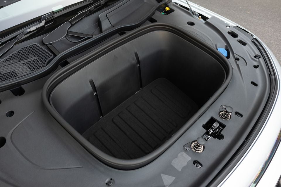 Front storage compartment (frunk) under the bonnet of the 2027 Mercedes-Benz GLB350 4Matic electric SUV, with a carpeted floor
