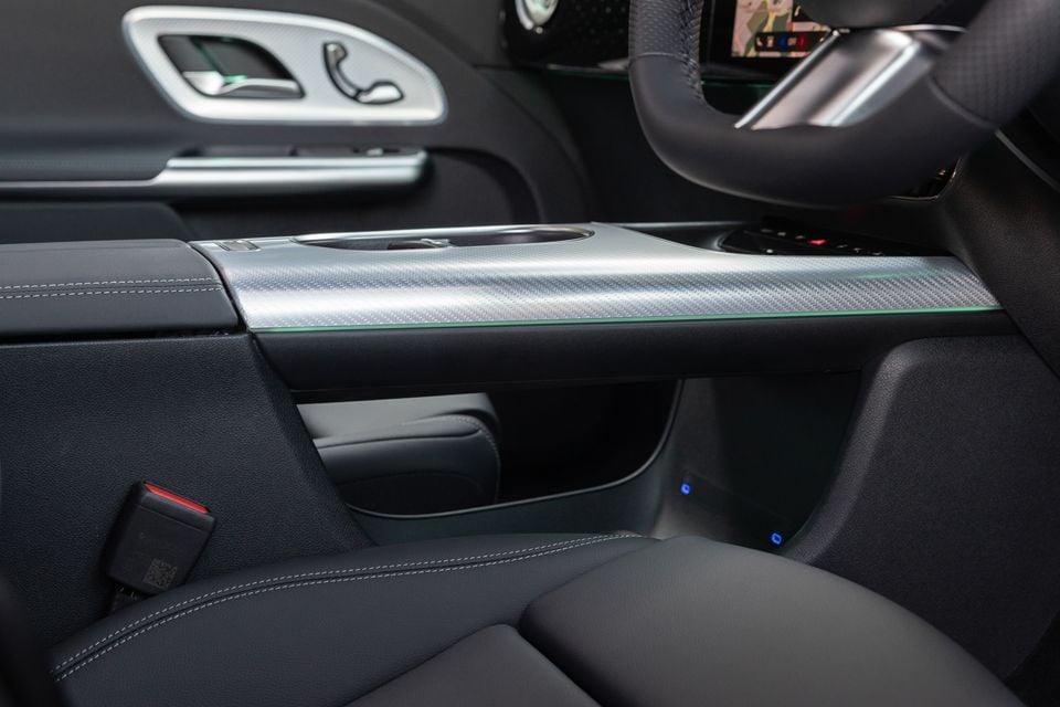 Centre console of the 2027 Mercedes-Benz GLB350 4Matic electric with carbon-look silver trim, ambient lighting, black leather seats and steering wheel