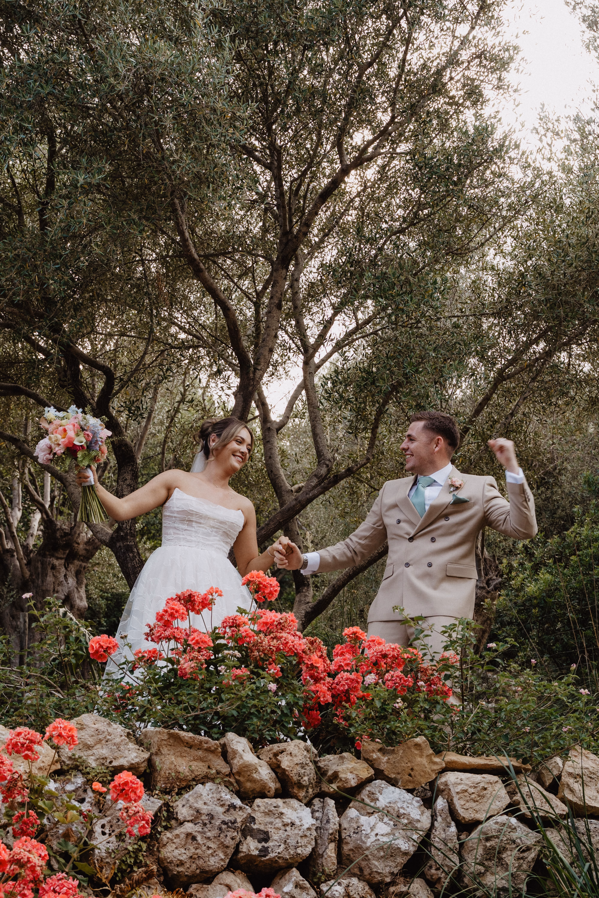 Mallorca Wedding Planner Dybiec Wedding Happiness Mode Photography 9 - How To Plan a Wedding in Mallorca From The UK, Part 2: Taking Your Wedding to Mallorca From the UK Bride and groom holding hands and looking happy at their wedding in Mallorca, planned by Dybiec Wedding