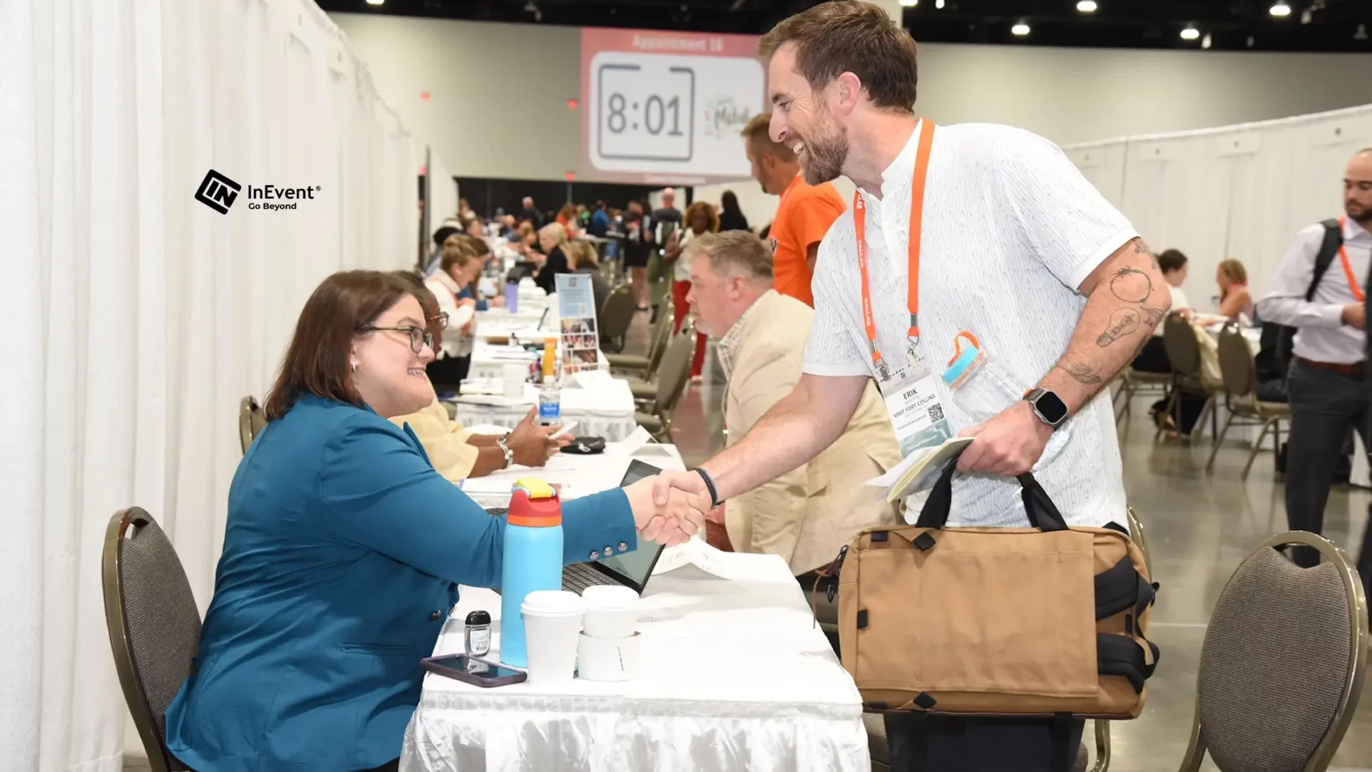 event staff welcoming guests at a registration desk