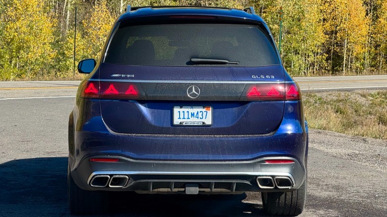 head-on shot of the rear of the blue GLS63 press car I had parked on asphalt in front of yellow trees