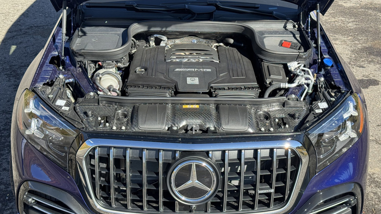 A look under the hood of the dark blue GLS press car I drove shwoing its AMG V8 while parked on asphalt