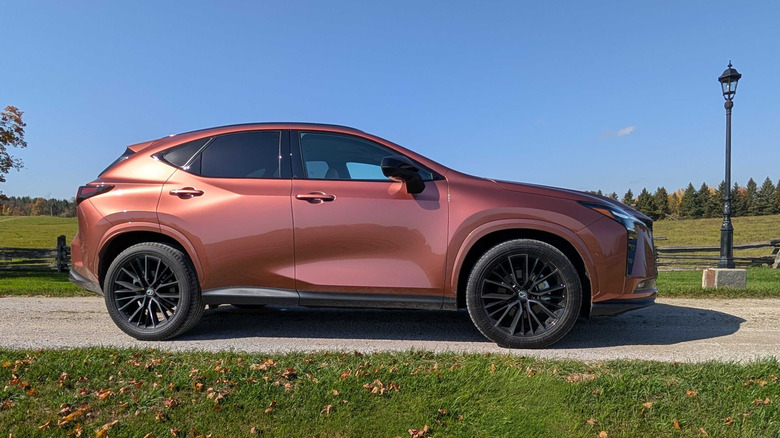 Side view of a 2027 Lexus NX in copper parked on a rural driveway in Ontario.