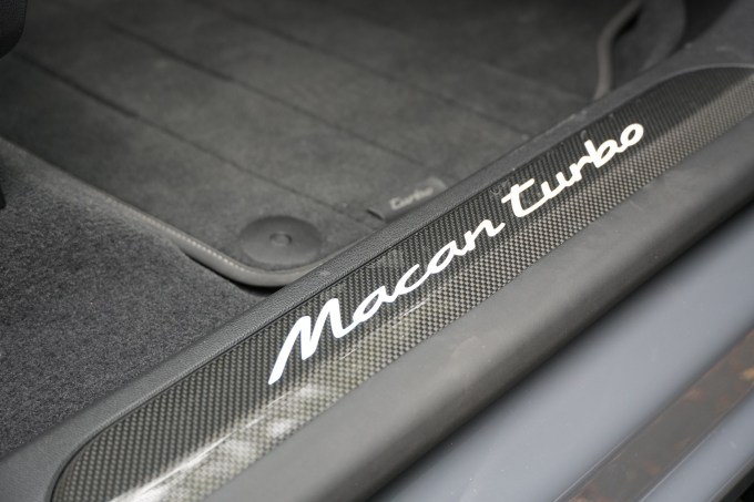 Carbon fiber door sills reflect light from above.