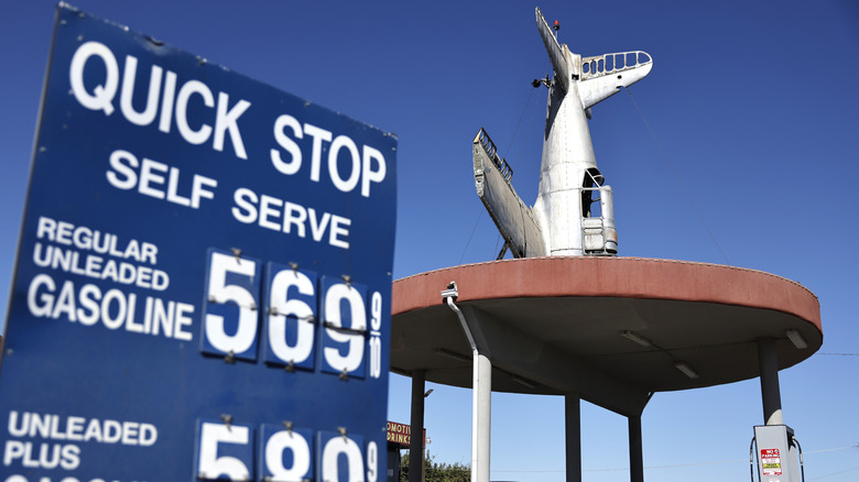 A customer stands at a gas station near gas prices displayed in California's 22nd Congressional District on October 17, 2026 near Fresno, California